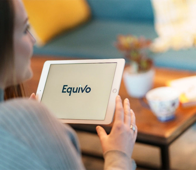 Woman holding a tablet showing Equivo debt payment portal homepage