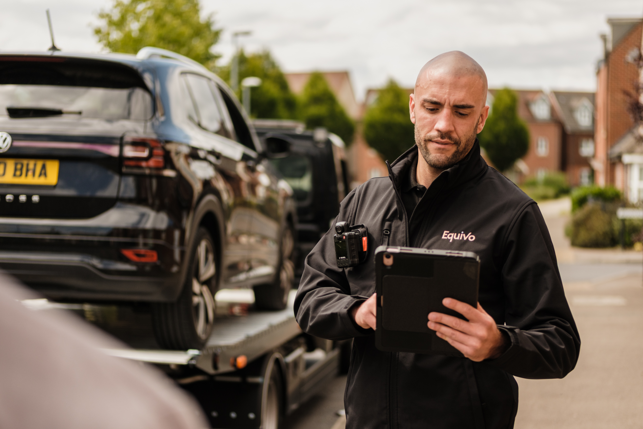 Equivo agent repossessing a car on his recovery truck 