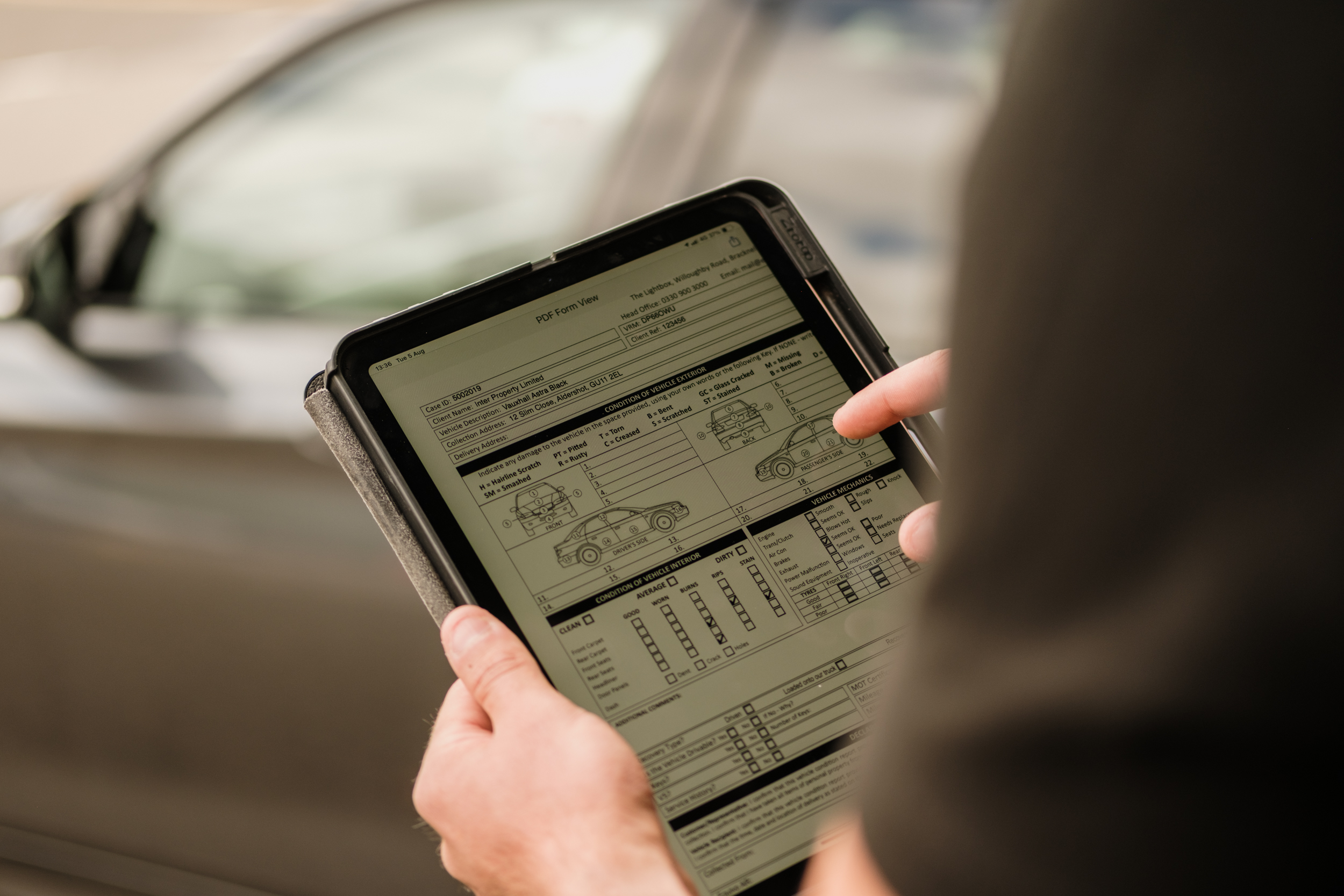 Agent carrying out their vehicle checks on iPad