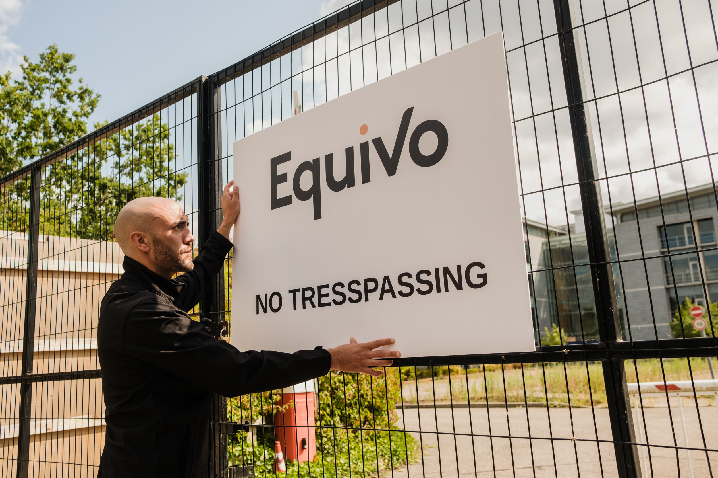 Enforcement agent putting up a no trespassing sign for squatter eviction service