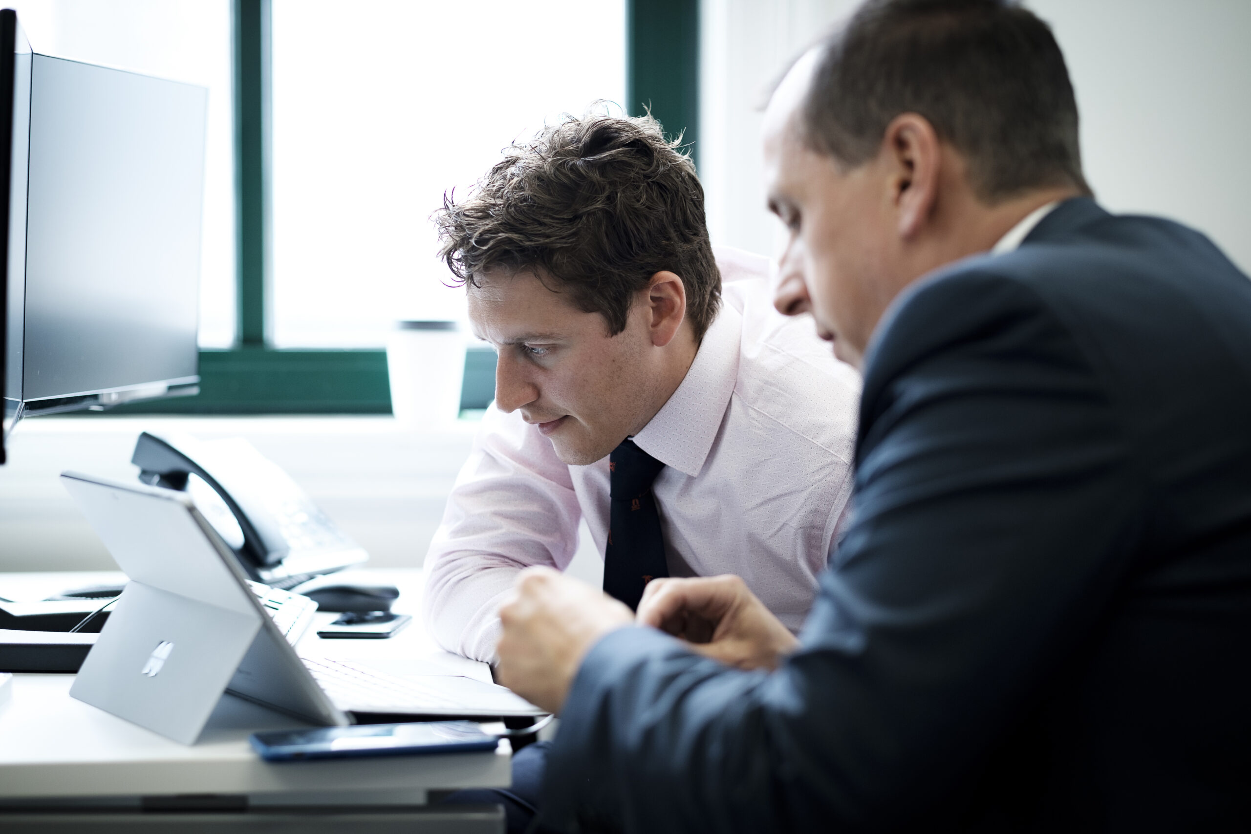 two professionals looking into a client case for debt recovery