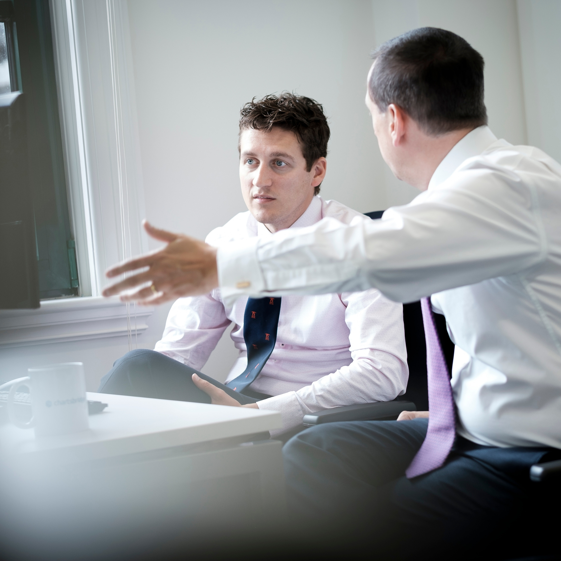 two professionals looking into a client case