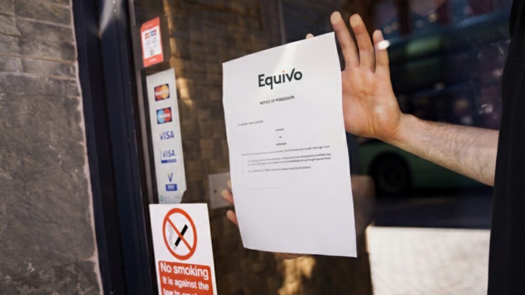 Enforcement agent putting up a notice of possession in a shop