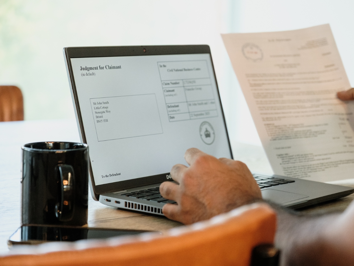 Professional with their laptop and paperwork for judgment