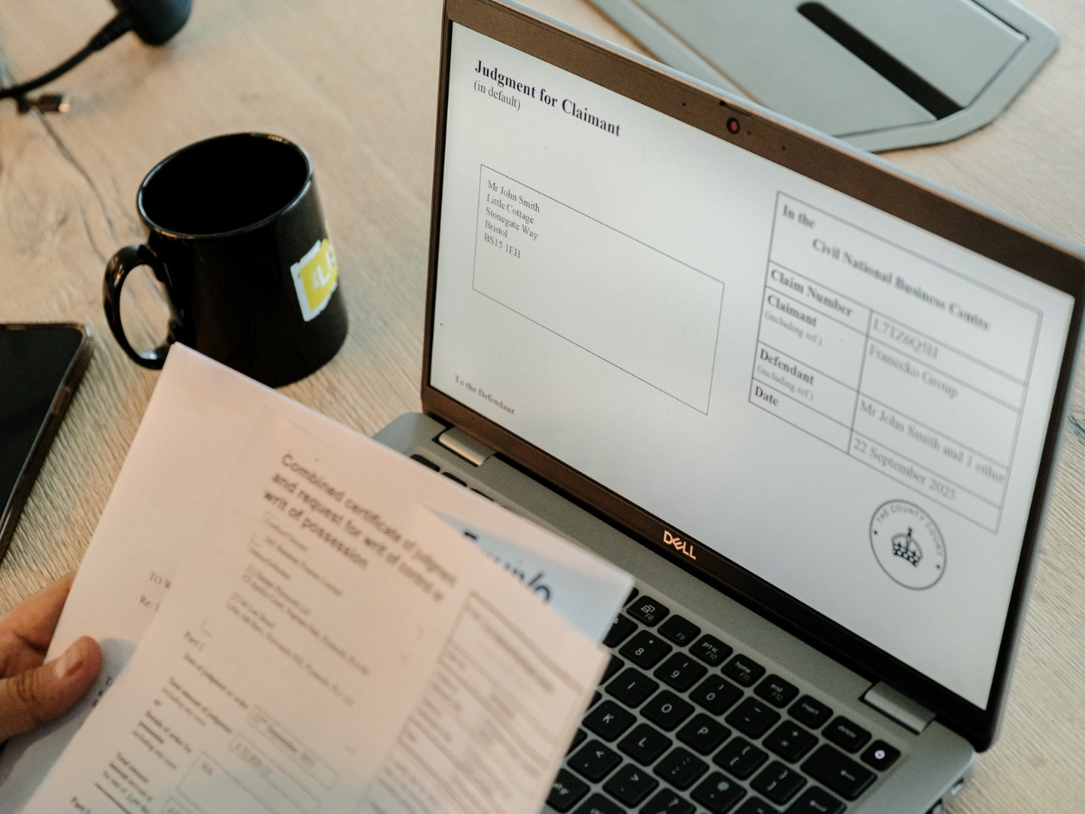 laptop with debt paperwork