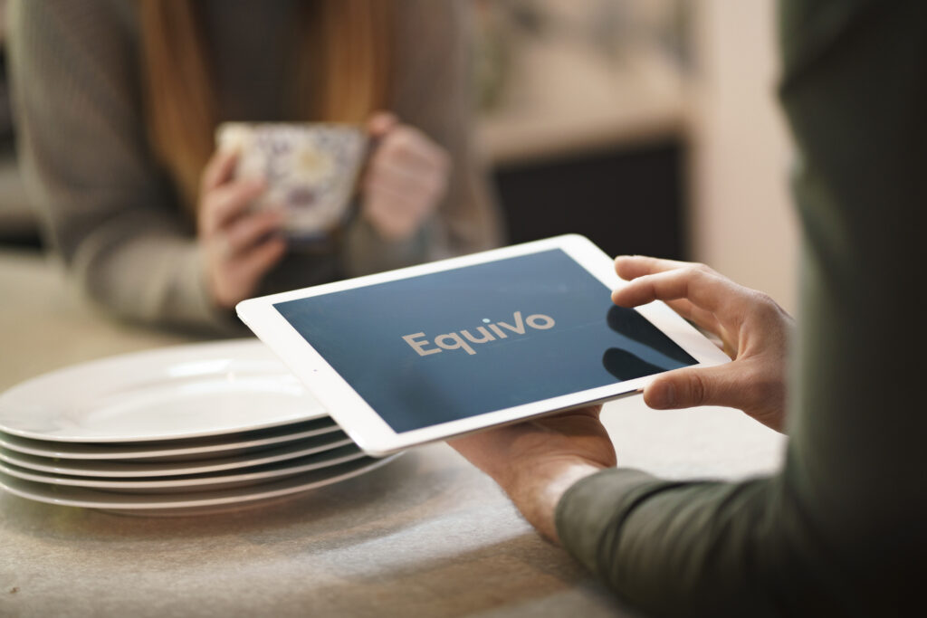 Equivo team providing support to a vulnerable customer using a tablet during a vehicle repossession.